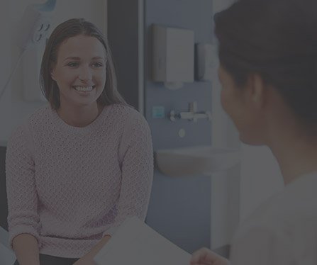 Female patient talking to dentist