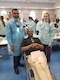 Dental patient with dentist and team member at community event