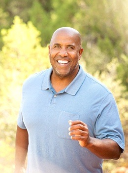 man walking smiling outside