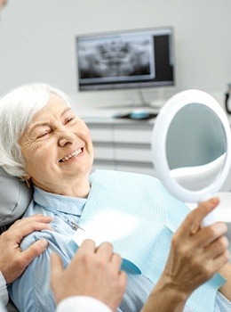 woman smiling looking in mirror