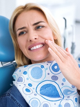 Woman with mouth pain in dental chair
