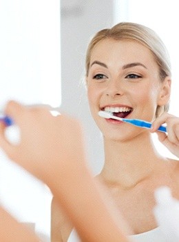 Woman brushing teeth