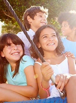 Four kids fishing outdoors