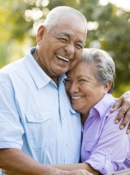 Smiling older man and woman outdoors