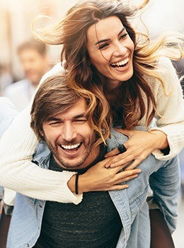 Smiling man and woman outdoors